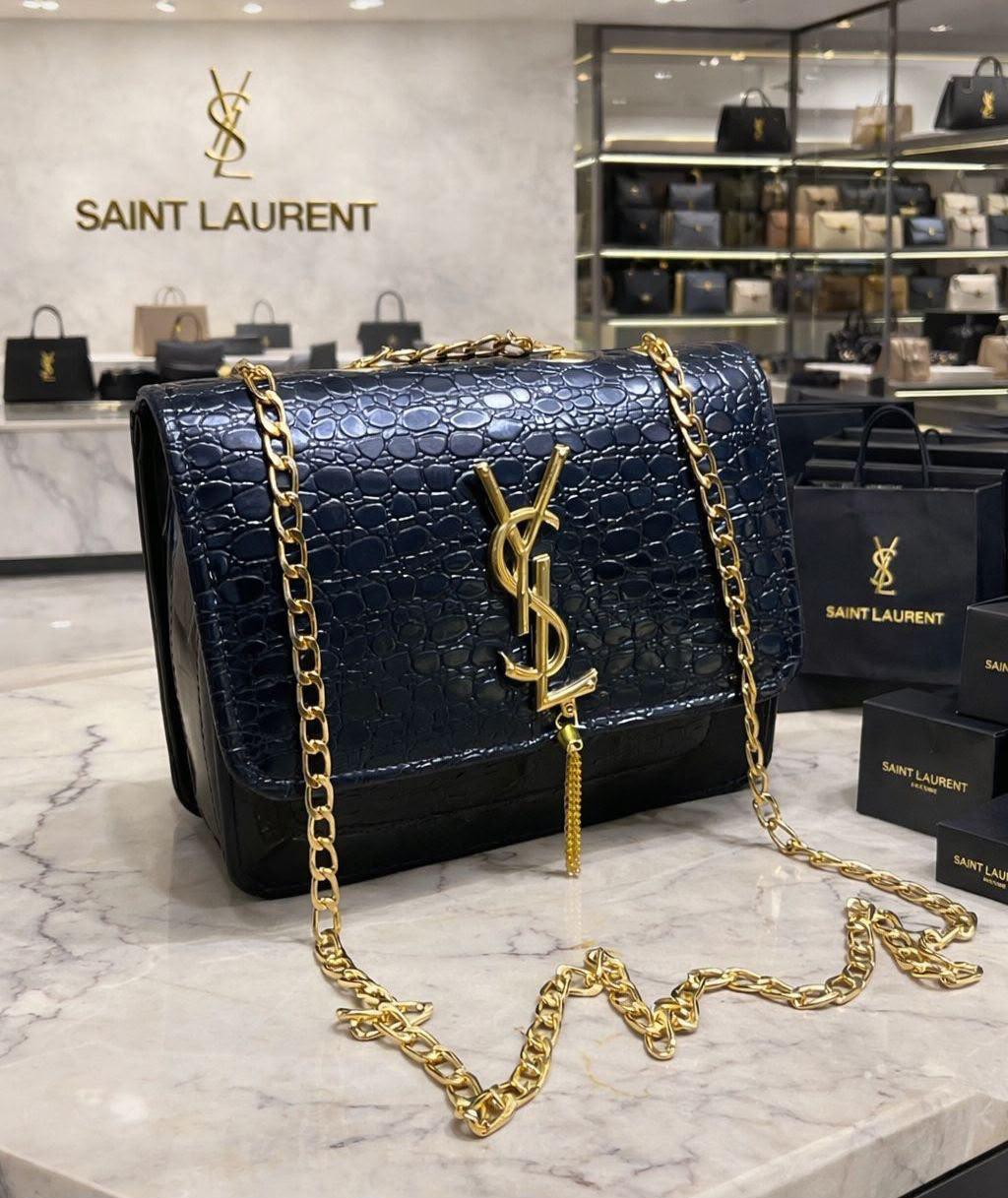 Long Chain Box Bag for Girls:   - Features a long chain for effortless wear   - Showcases a front YSL emblem for an elegant appearance   - Designed in a convenient side crossbody style